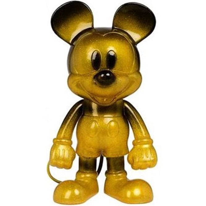 Gold Mickey Mouse figurine on a white background