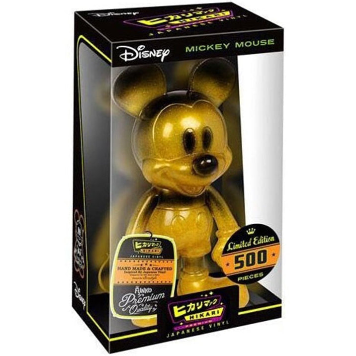 Gold Mickey Mouse figurine in a Disney packaging with limited edition details.